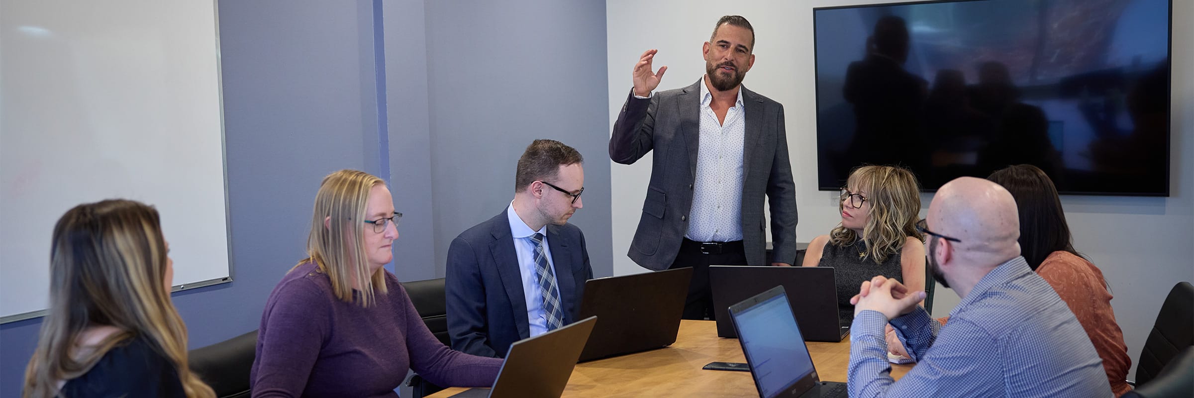 Legal professionals collaborating in a modern office boardroom