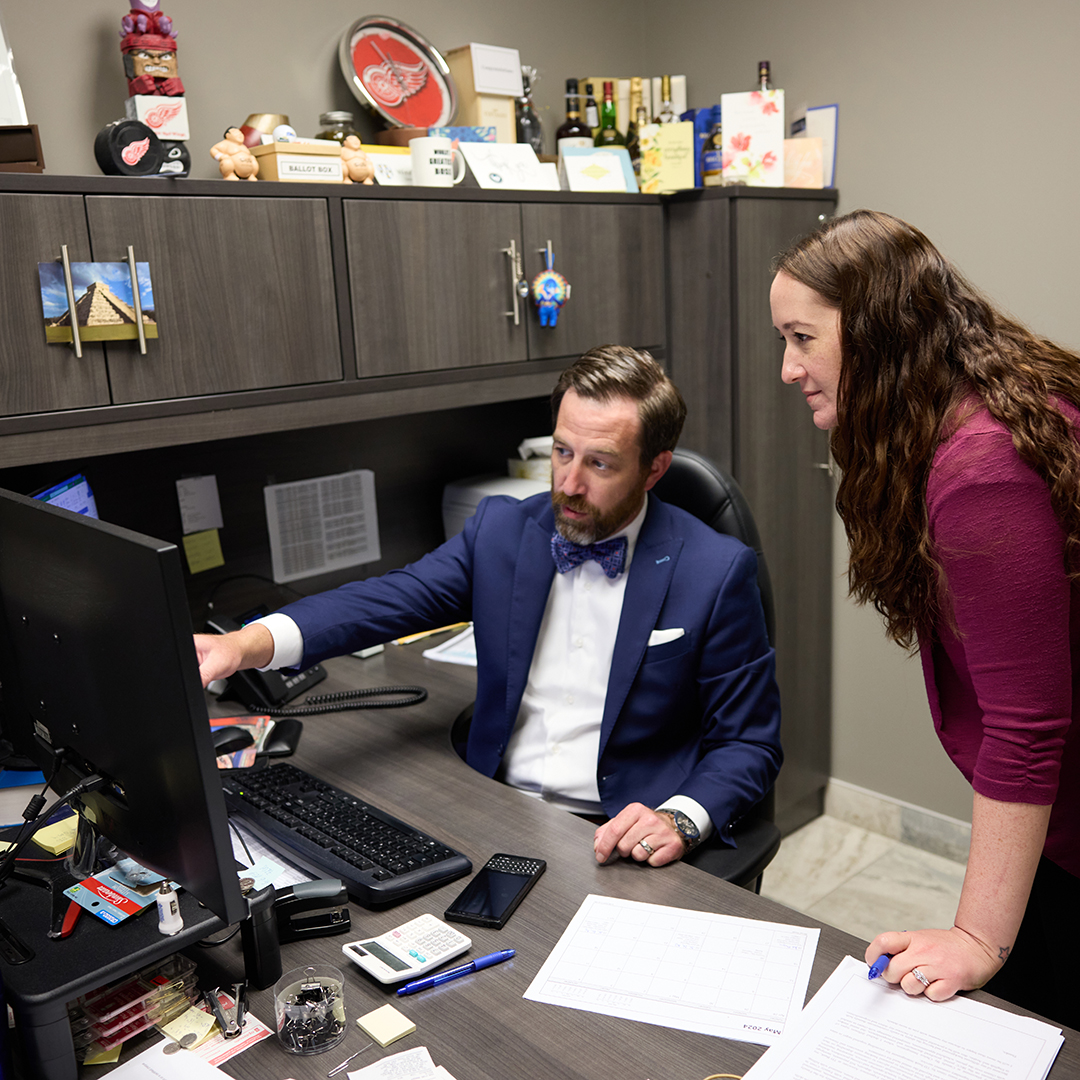 A Diamond and Diamond lawyer reviewing a file with a team member at the Windsor office.